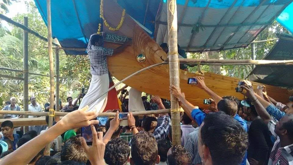 Nadubhagam Chundan being prepared beside the river