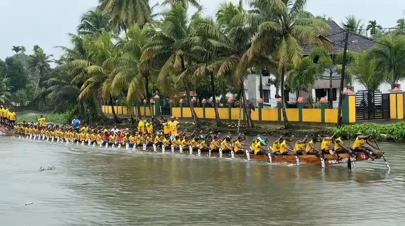 Nadubhagam Chundan and its rowers on the water
